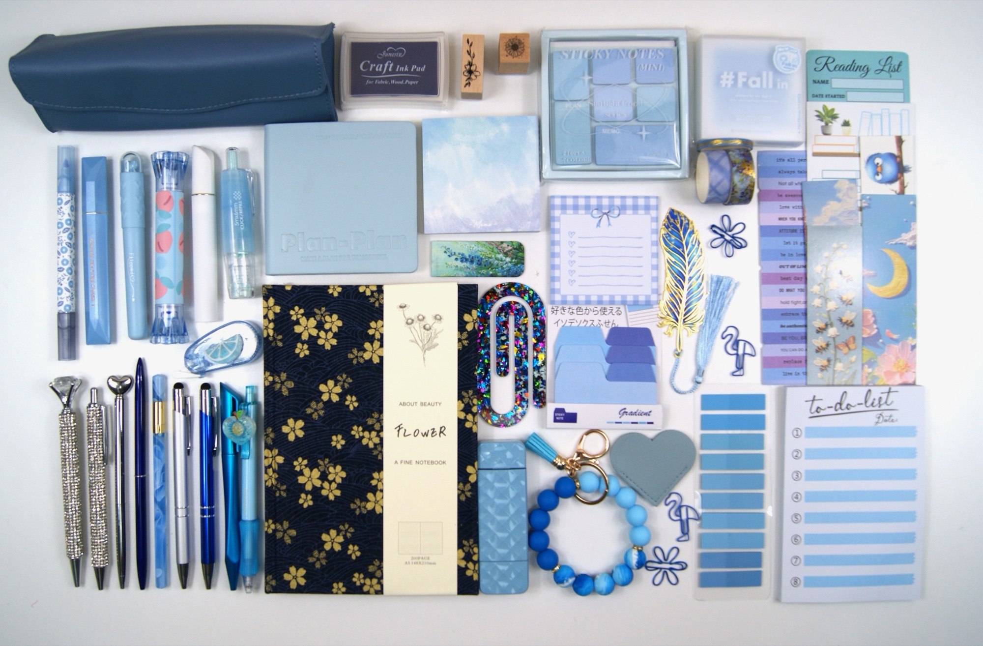The Indulgence Collection in Midnight Blue, with colour-coordinated stationery and reading accessories laid out on a pale background